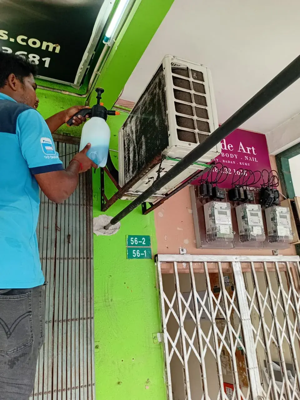 Real Mavis Eco Cool aircond technician on the job in Kuala Lumpur